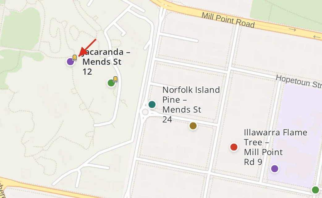 A close-up of the map with labels on and two features bookmarked: bookmark badges against their symbols, the bookmarked labels bold, and an arrow pointing at one badge.